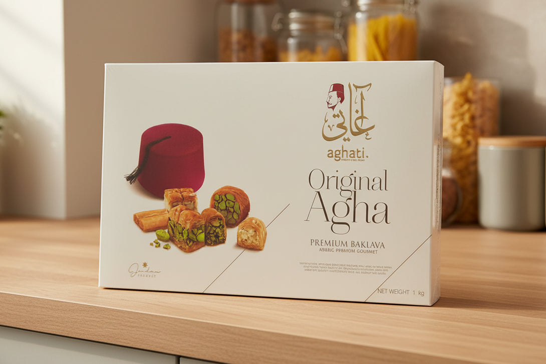 Box of Original Agha pastries held by a person with a price tag in the background.