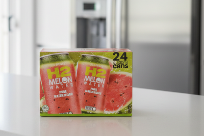 Box of Melon Water cans on a kitchen counter with a refrigerator in the background